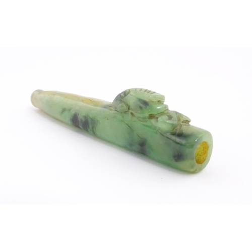 1026 - An Oriental jade coloured hardstone cheroot mouthpiece / holder with carved detail. Approx. 4 1/2