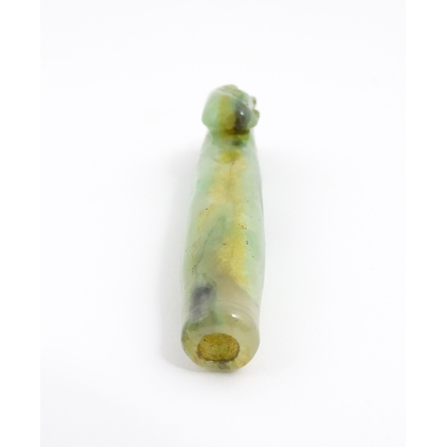 1026 - An Oriental jade coloured hardstone cheroot mouthpiece / holder with carved detail. Approx. 4 1/2