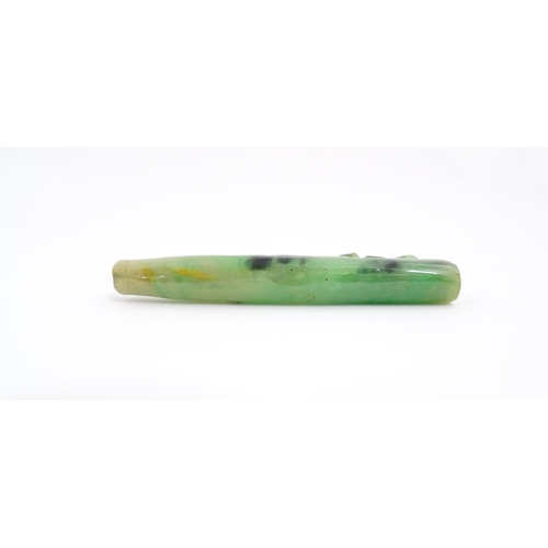 1026 - An Oriental jade coloured hardstone cheroot mouthpiece / holder with carved detail. Approx. 4 1/2