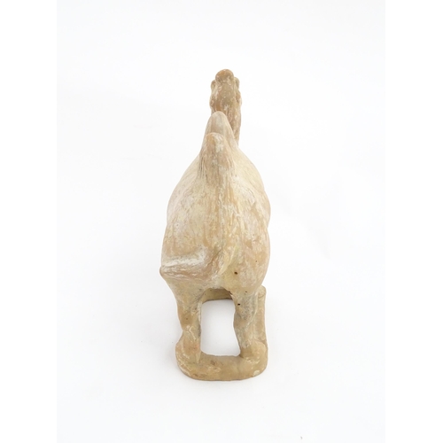 1027 - A Chinese Tang dynasty pottery model of a camel. Approx. 11 1/2