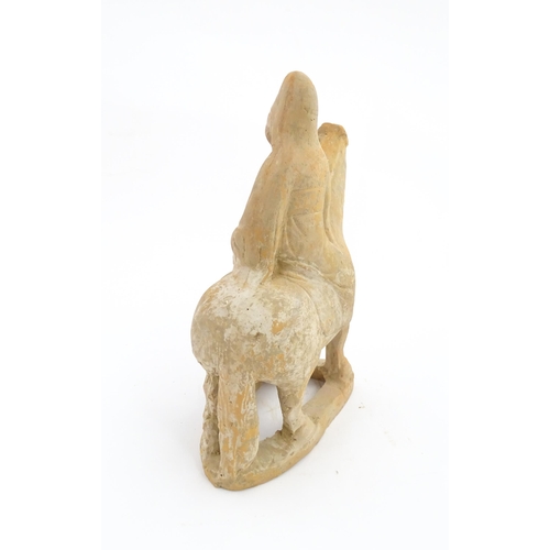 1029 - A Chinese Tang dynasty pottery model of a horse and rider. Approx. 10 1/2