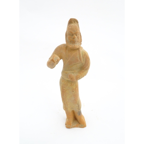 1030 - A Chinese Tang dynasty pottery figure modelled as a horse groom. Approx. 13 1/4