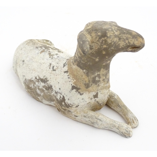 1032 - A Chinese Han dynasty pottery model of a recumbent sheep. Approx. 6 3/4