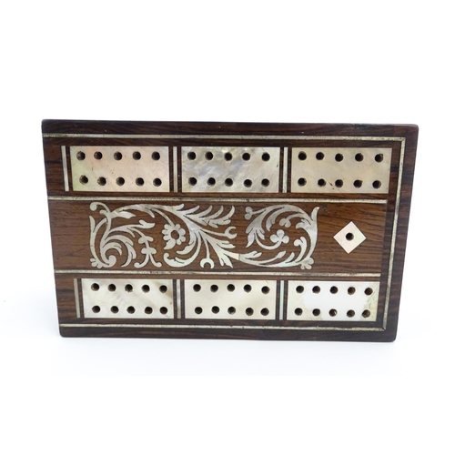 1039 - A late 19th / early 20thC rosewood cribbage board with inlaid mother of pearl decoration. Together w... 