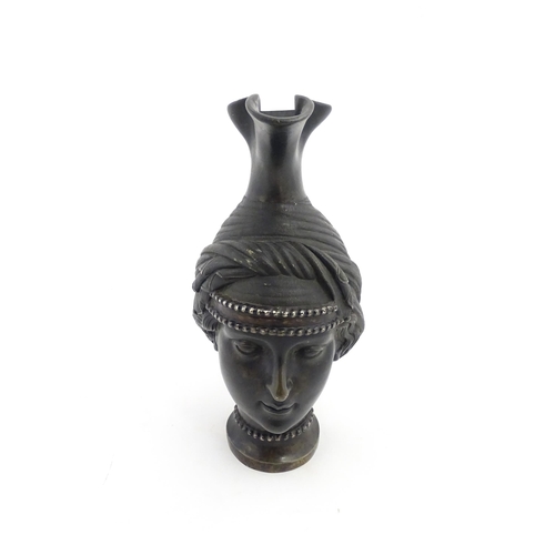 1059 - A Continental cast wine ewer of female head form, in the Etruscan style. Approx. 9 1/2