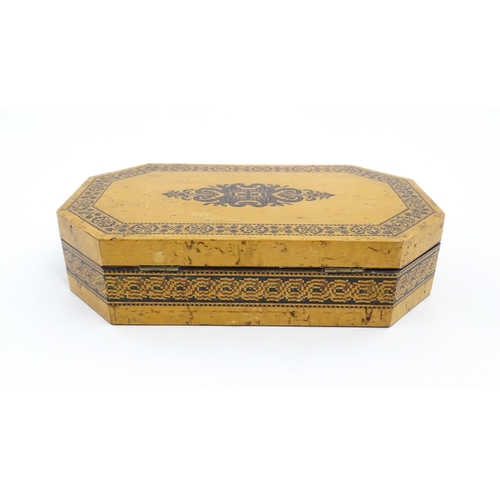 1062 - A 19thC Tunbridge ware games box of octagonal form with banded decoration, opening to reveal four se... 