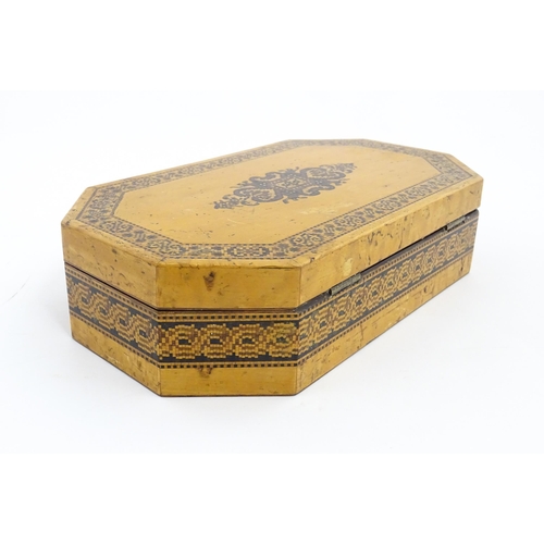 1062 - A 19thC Tunbridge ware games box of octagonal form with banded decoration, opening to reveal four se... 