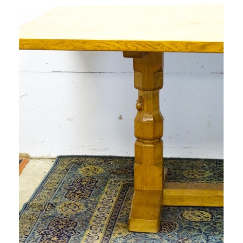 1583 - A mid to late 20thC Robert 'Mouseman' Thompson dining table. The 8ft long oak table top with an adze... 