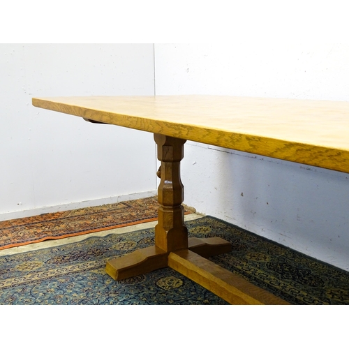 1583 - A mid to late 20thC Robert 'Mouseman' Thompson dining table. The 8ft long oak table top with an adze... 