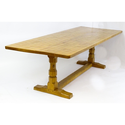 1583 - A mid to late 20thC Robert 'Mouseman' Thompson dining table. The 8ft long oak table top with an adze... 