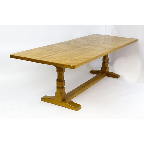 1583 - A mid to late 20thC Robert 'Mouseman' Thompson dining table. The 8ft long oak table top with an adze... 