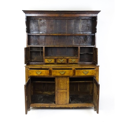 1591 - A mid 18thC oak dresser with a moulded cornice above three graduated shelves flanked by panelled cup... 