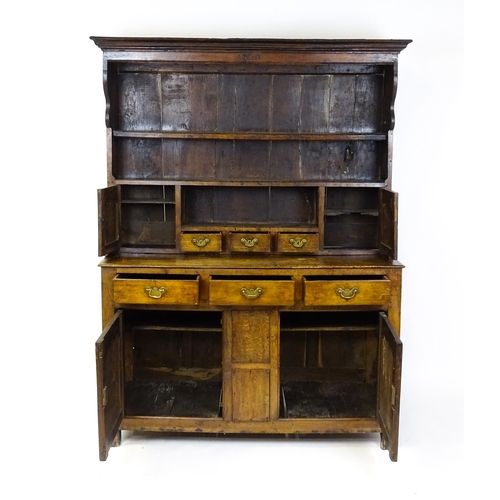 1591 - A mid 18thC oak dresser with a moulded cornice above three graduated shelves flanked by panelled cup... 