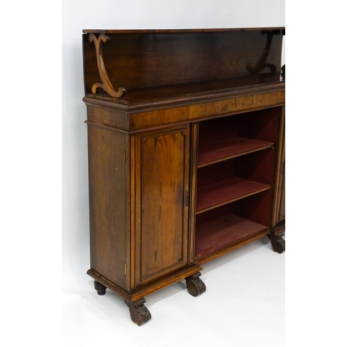 1593 - A 19thC rosewood bookcase with a moulded shelf raised on two scrolled brackets, the base having two ... 