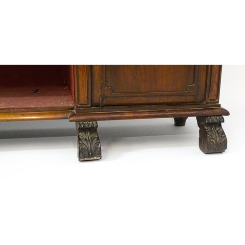 1593 - A 19thC rosewood bookcase with a moulded shelf raised on two scrolled brackets, the base having two ... 