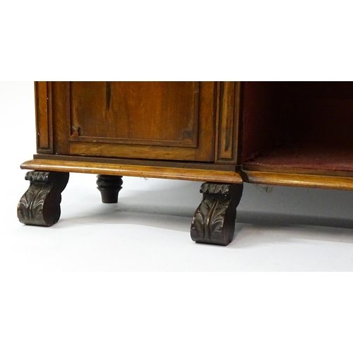 1593 - A 19thC rosewood bookcase with a moulded shelf raised on two scrolled brackets, the base having two ... 