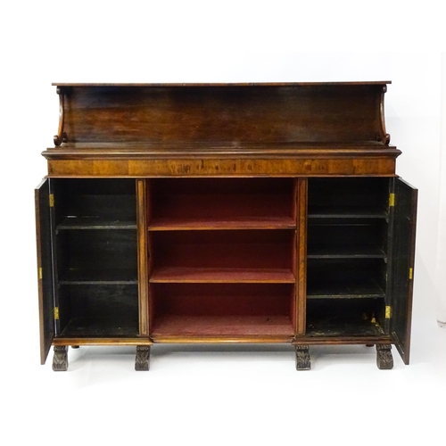 1593 - A 19thC rosewood bookcase with a moulded shelf raised on two scrolled brackets, the base having two ... 