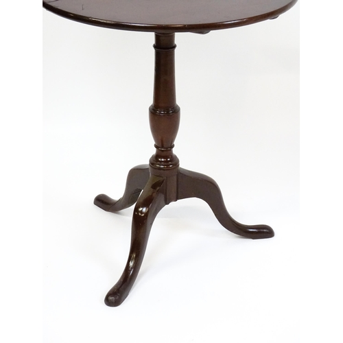 1594 - A 19thC mahogany tripod table with a turned pedestal above three cabriole legs. 27