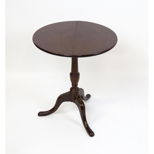 1594 - A 19thC mahogany tripod table with a turned pedestal above three cabriole legs. 27