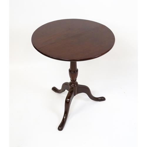 1594 - A 19thC mahogany tripod table with a turned pedestal above three cabriole legs. 27