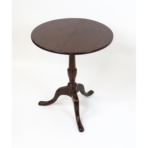 1594 - A 19thC mahogany tripod table with a turned pedestal above three cabriole legs. 27