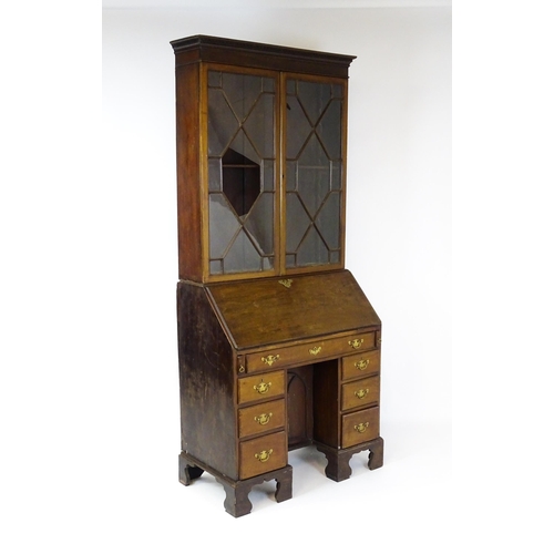 1602 - A Georgian mahogany bureau bookcase, with a moulded top above two astragal glazed doors and a fall f... 