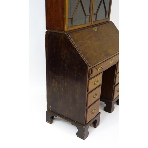 1602 - A Georgian mahogany bureau bookcase, with a moulded top above two astragal glazed doors and a fall f... 