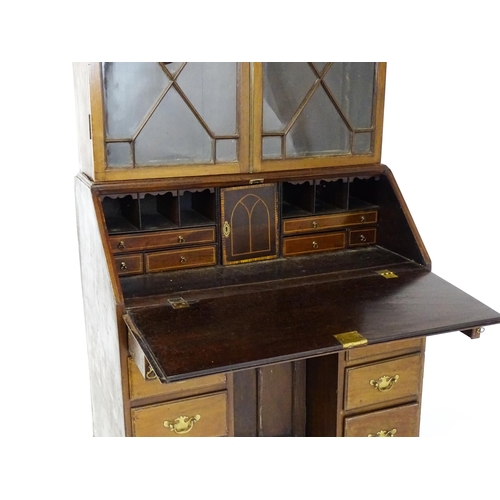 1602 - A Georgian mahogany bureau bookcase, with a moulded top above two astragal glazed doors and a fall f... 