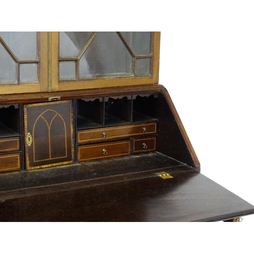 1602 - A Georgian mahogany bureau bookcase, with a moulded top above two astragal glazed doors and a fall f... 