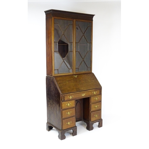 1602 - A Georgian mahogany bureau bookcase, with a moulded top above two astragal glazed doors and a fall f... 