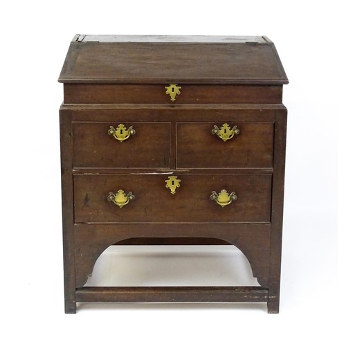 1603 - An early / mid 18thC mahogany clerks desk with a hinged sloping lid opening to show a fitted interio... 