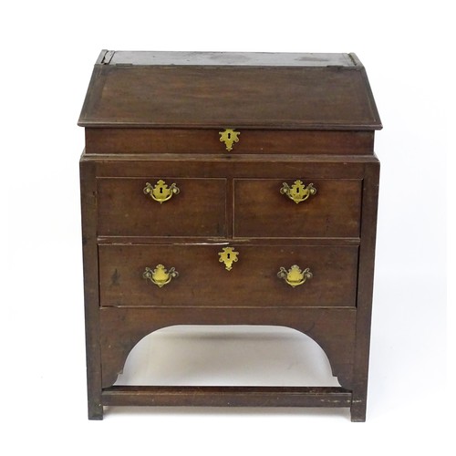 1603 - An early / mid 18thC mahogany clerks desk with a hinged sloping lid opening to show a fitted interio... 