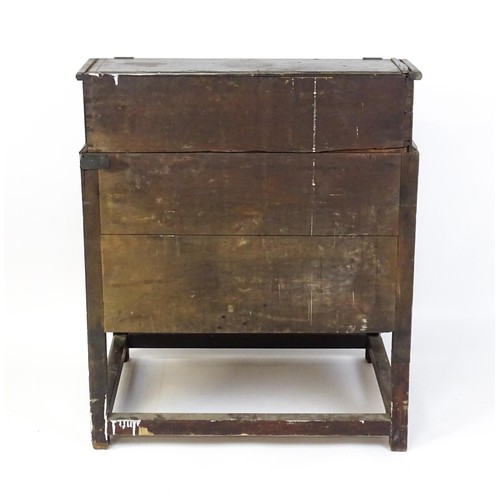 1603 - An early / mid 18thC mahogany clerks desk with a hinged sloping lid opening to show a fitted interio... 