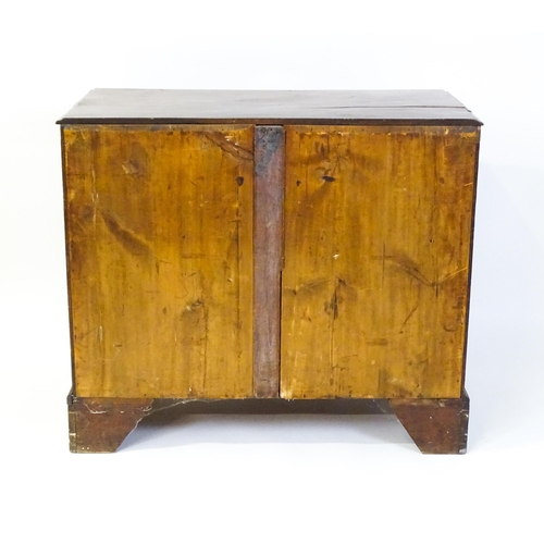 1611 - A late Georgian mahogany chest of drawers with a rectangular moulded top above three long drawers wi... 