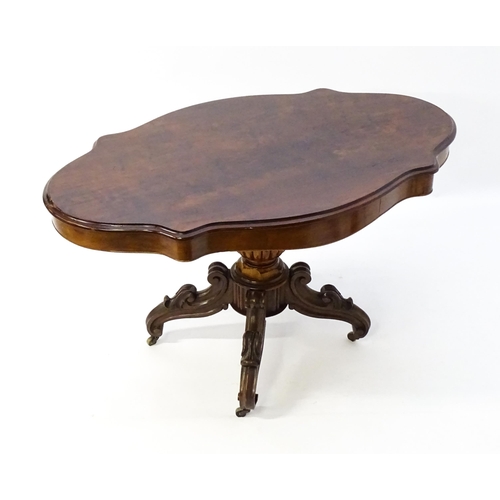 1620 - A 19thC mahogany centre table with a moulded top having two frieze drawers, the pedestal having gadr... 