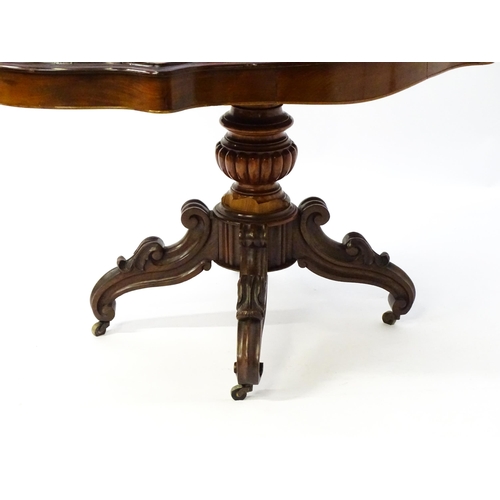 1620 - A 19thC mahogany centre table with a moulded top having two frieze drawers, the pedestal having gadr... 