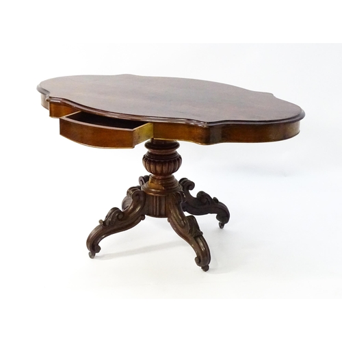 1620 - A 19thC mahogany centre table with a moulded top having two frieze drawers, the pedestal having gadr... 