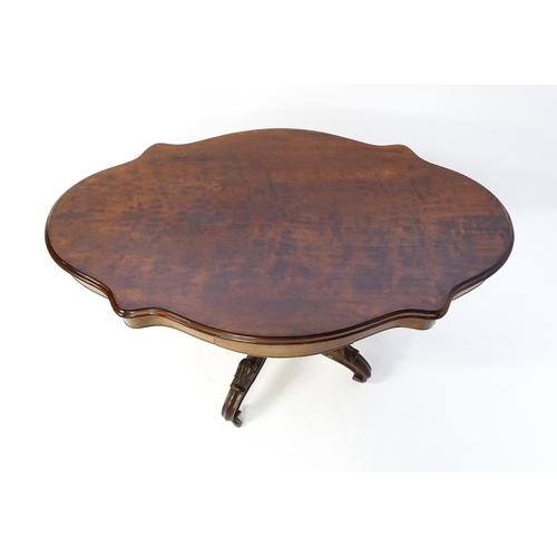 1620 - A 19thC mahogany centre table with a moulded top having two frieze drawers, the pedestal having gadr... 