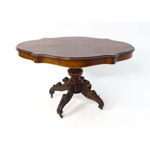 1620 - A 19thC mahogany centre table with a moulded top having two frieze drawers, the pedestal having gadr... 