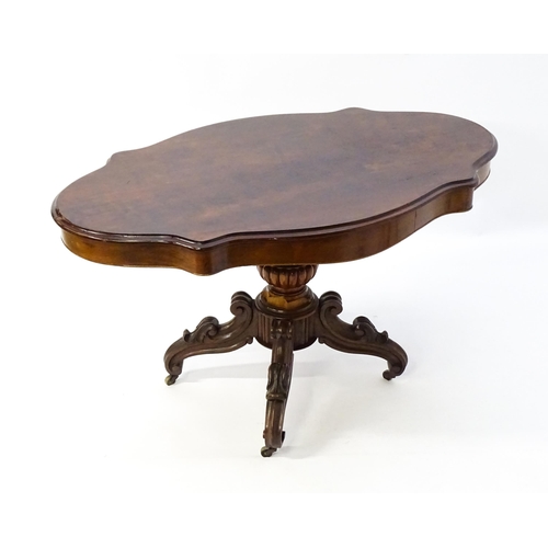 1620 - A 19thC mahogany centre table with a moulded top having two frieze drawers, the pedestal having gadr... 