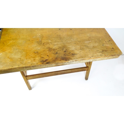 1625 - A mid / late 20thC artists desk with a hinged, adjustable top raised on tapering legs united by a bo... 