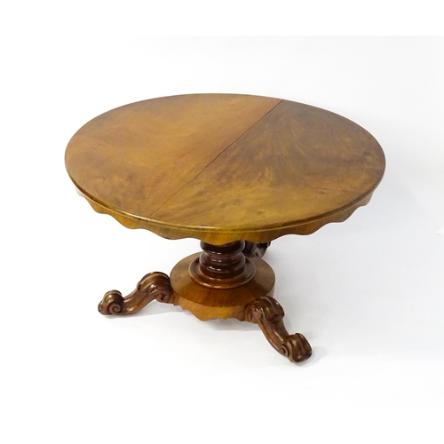 1634 - A 19thC mahogany tilt top breakfast table with a carved frieze above a turned and carved pedestal ba... 