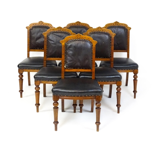 1651 - A set of six late 19thC oak Gothic style dining chairs with floral carved top rails, fluted uprights... 