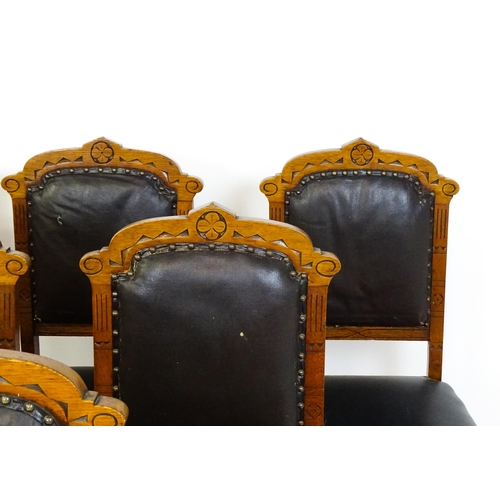 1651 - A set of six late 19thC oak Gothic style dining chairs with floral carved top rails, fluted uprights... 