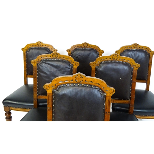 1651 - A set of six late 19thC oak Gothic style dining chairs with floral carved top rails, fluted uprights... 