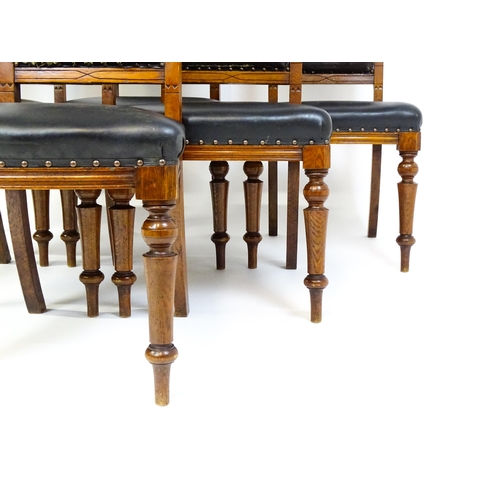 1651 - A set of six late 19thC oak Gothic style dining chairs with floral carved top rails, fluted uprights... 