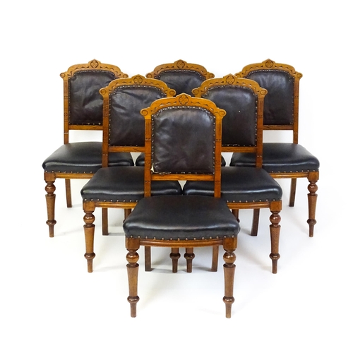 1651 - A set of six late 19thC oak Gothic style dining chairs with floral carved top rails, fluted uprights... 