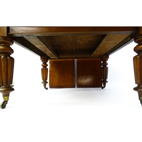 1652 - A 19thC mahogany dining table with a moulded top above turned, reeded and tapering legs terminating ... 