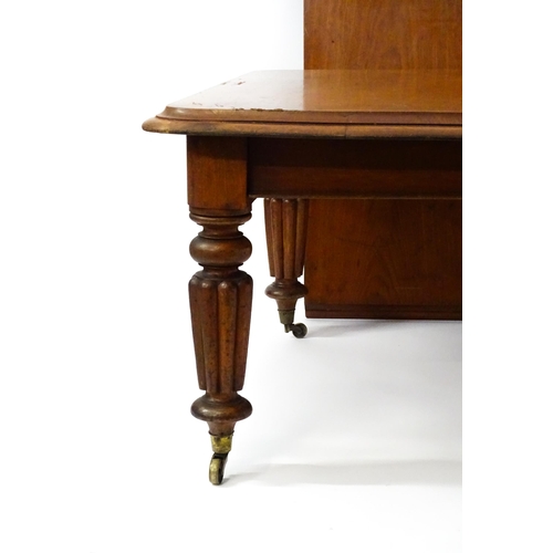 1652 - A 19thC mahogany dining table with a moulded top above turned, reeded and tapering legs terminating ... 