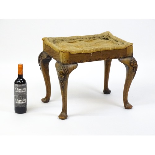 1658 - An early 20thC stool raised on four shell carved cabriole legs terminating in pad feet. 20